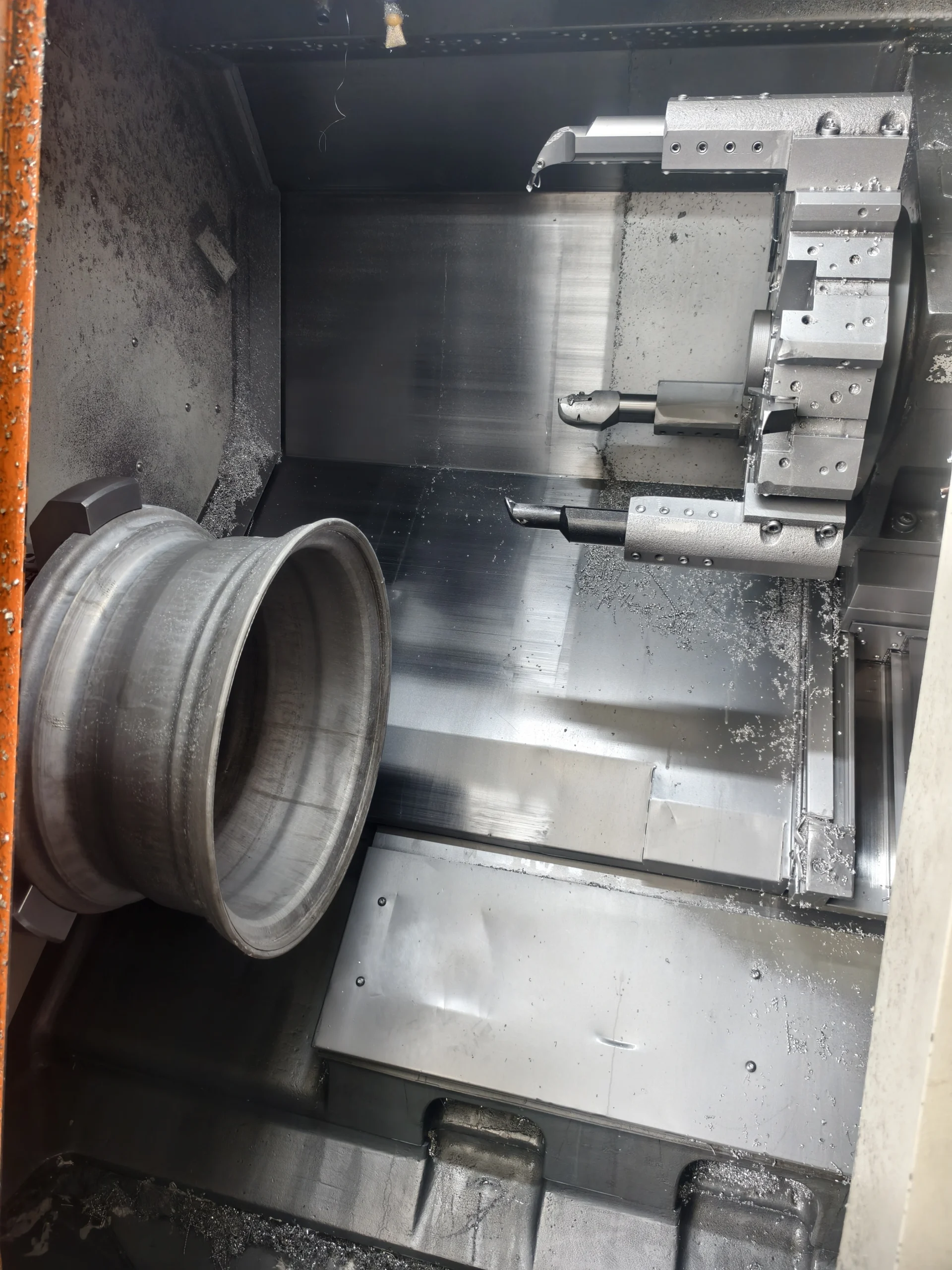 Forged wheel blank being shaped on a lathe